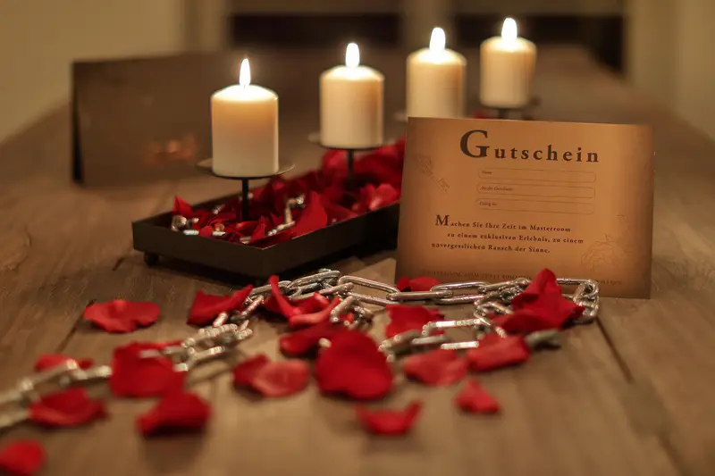 Masterroom gift voucher with rose petals, chains and candles